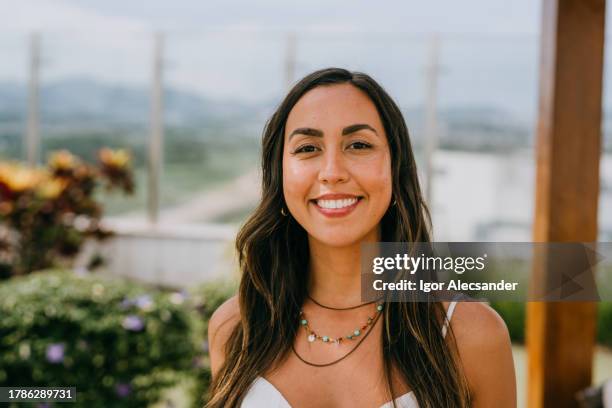 portrait of a smiling latin woman in a garden